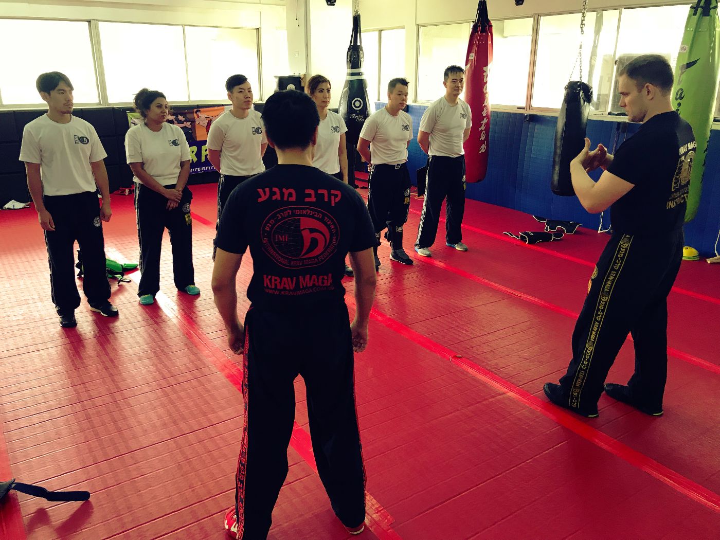 Krav Maga Instructor explaining to Krav Maga students how the technique works